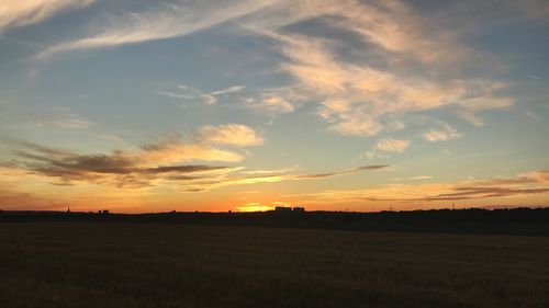 Scenic view of field against sky during sunset