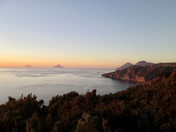 Scenic view of sea against clear sky during sunset