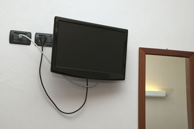 Low angle view of television set on wall