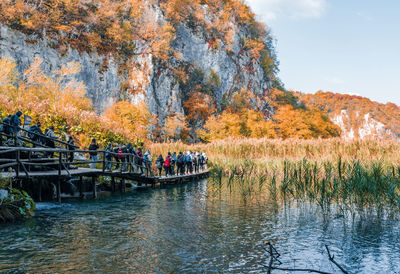 Kids on a field trip in plitvice lakes national park in croatia in autumn.