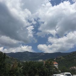 Scenic view of mountains against cloudy sky