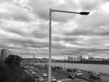 View of cityscape against cloudy sky