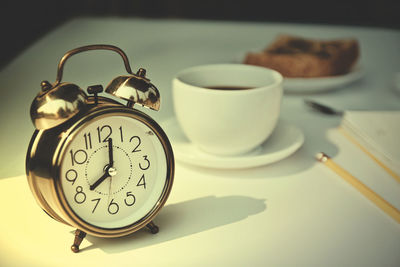 Close-up of clock on table