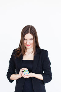 Young woman smiling against white background