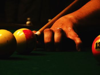 Close-up of hand playing pool