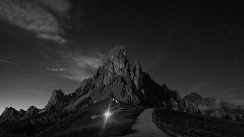 Scenic view of illuminated mountains against sky at night