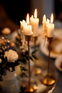 Close-up of lit candles on table