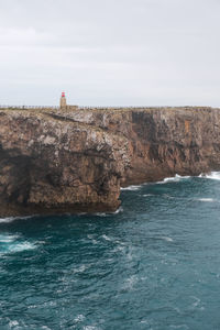 Rock formations by sea against sky