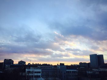 Buildings against cloudy sky