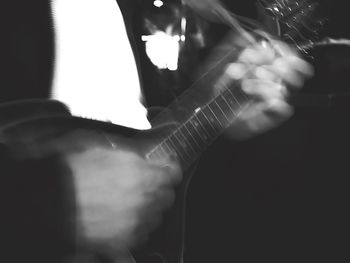Close-up of man playing guitar