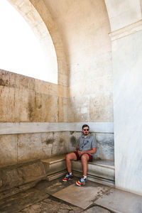 Full length of young man sitting on staircase