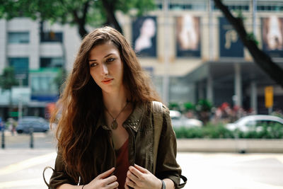 Portrait of young woman in city