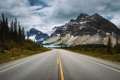 Road by mountain against sky