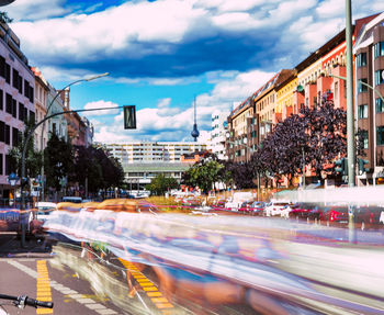 View of city street and buildings against sky