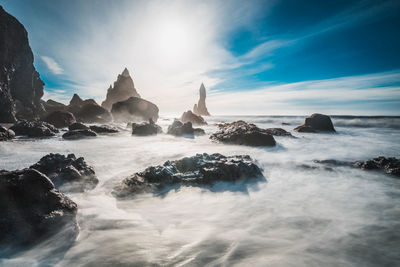 Rock formations amidst sea against sky