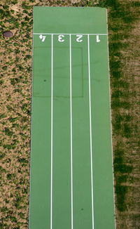 High angle view of arrow sign on field