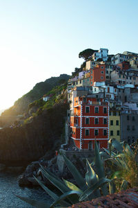 Buildings in city against clear sky