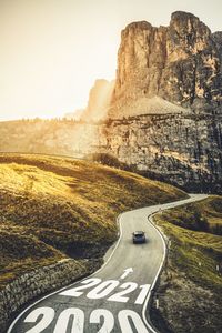 Road passing through rock formations against sky