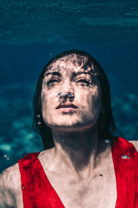 Close-up portrait of young man swimming in sea