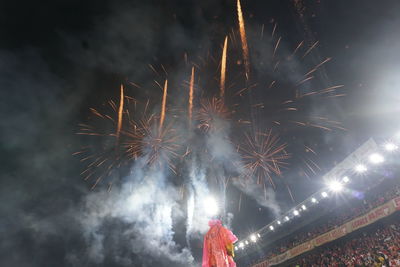 Low angle view of firework display at night