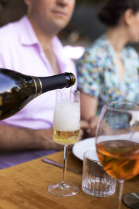 Midsection of woman holding wineglass