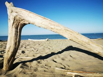 Scenic view of beach against clear blue sky