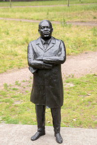 Portrait of man standing against sculpture