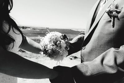 Close-up of hand holding flowers in car