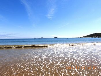 Scenic view of sea against blue sky