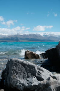 Rocks on beach against sky