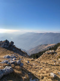 Scenic view of mountains against clear blue sky