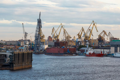 Ship building plant. large cranes build various vessels. dry dock. pier with ships.