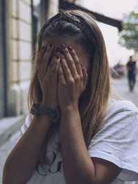 Portrait of woman covering face