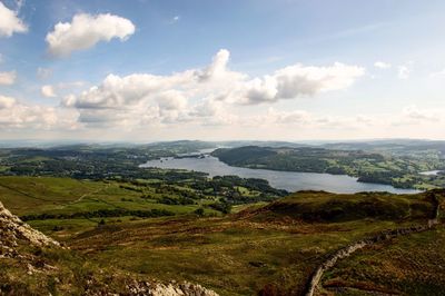 Scenic view of river and landscape against sky