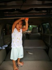 Girl standing on seat in car