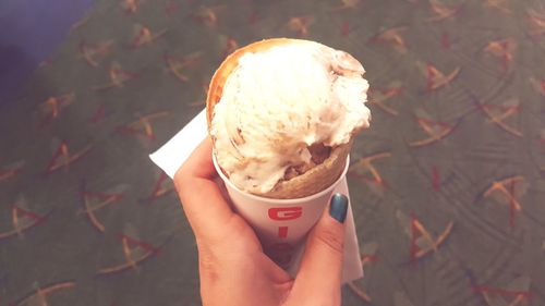 Close-up of woman holding ice cream cone