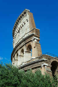 Low angle view of historical building against blue sky