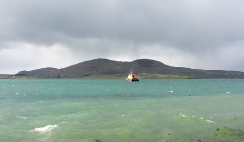 Scenic view of sea against cloudy sky