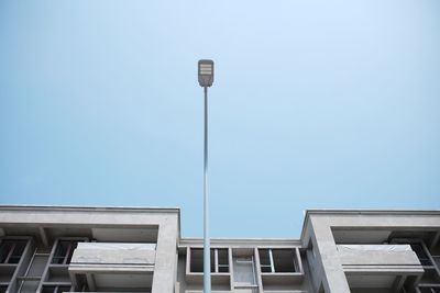 Low angle view of street light against building