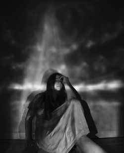 Low angle view of woman standing against wall