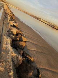 Scenic view of beach against sky during sunset