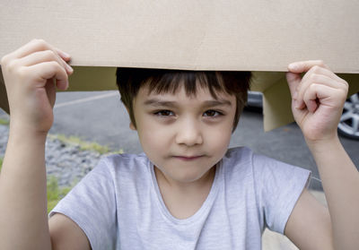 Portrait of cute boy holding baby