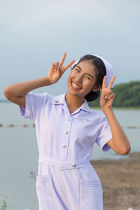 Smiling young nurse on field