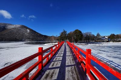 Scenic view of snowcapped mountains against blue sky