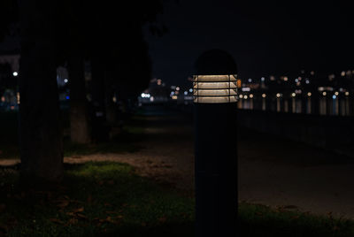 Illuminated street light in city at night