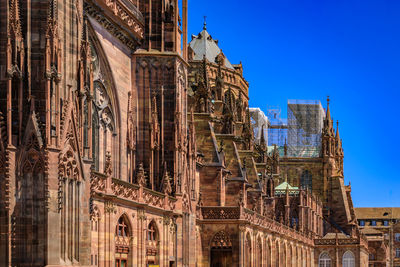 Low angle view of historic building against clear blue sky