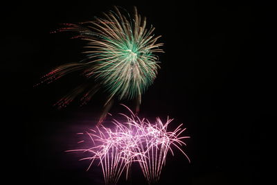Low angle view of firework display at night