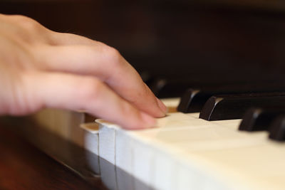 Cropped hand playing piano