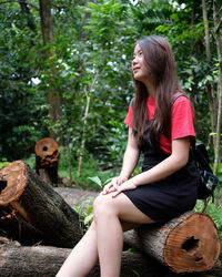 Young woman sitting in forest