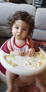 Portrait of cute girl sitting at home